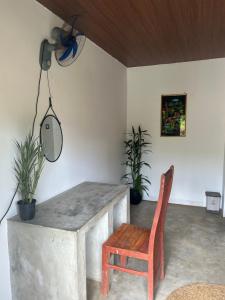 a room with a table and a chair and a light at Cabana Unawatuna in Unawatuna +8 photos