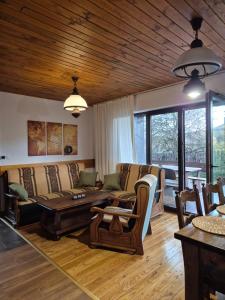 a living room with a couch and a table at Hereczówka in Laskówka +43 photos