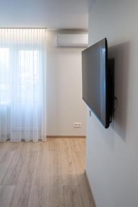 a flat screen tv hanging on a wall at Vytauto 12 in Marijampolė