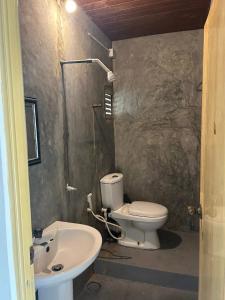 a bathroom with a toilet and a sink at Cabana Unawatuna in Unawatuna