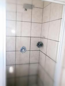 a tiled shower with two toilets in a room at Luxury Living in Jbay in Jeffreys Bay