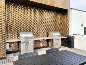 un patio avec deux tabourets et un mur en briques dans l'établissement Melrose Luxe Retreat near The Grove, à Los Angeles