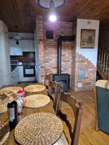 a kitchen with three tables and a stove in a room at Hereczówka in Laskówka