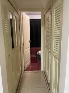 a hallway of a bathroom with a toilet and a door at Comfortable apartment, excellent location in Maracaibo +15 photos
