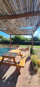 a group of picnic tables under a wooden umbrella at El Nevado Casa de Campo 2 in San Rafael
