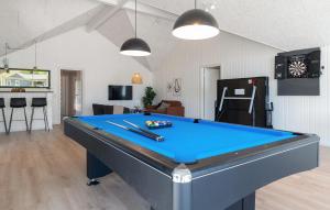 a pool table in a living room with a pool at Awesome Home In Glesborg With Sauna in Fjellerup