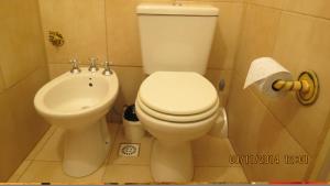 a bathroom with a toilet and a bidet at Cabañas Entre Verde in Los Hornillos +29 photos