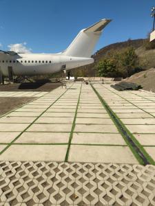 a plane is parked on a runway next to a mountain at Lostin clouds in Yenokavan