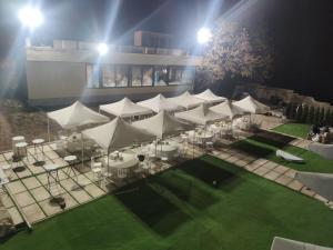an overhead view of a marquee with tables and white umbrellas at Lostin clouds in Yenokavan