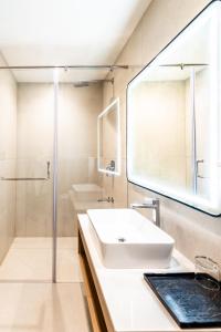 a bathroom with a sink and a mirror at Hotel Lenexa by Bestinn Leisure in Bengaluru
