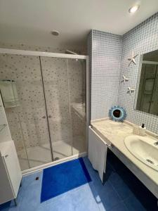 a bathroom with a glass shower and a sink at Sil&Sol in Arona