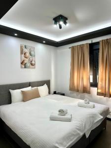 a bedroom with a large bed with two towels on it at Prenoćište Vozač in Jajce