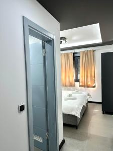 a bedroom with a bed and a glass door at Prenoćište Vozač in Jajce +21 photos