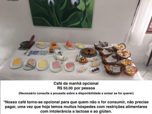 a table with different types of food on it at POUSADA NOSSA SENHORA in Penedo