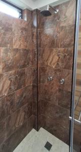 a shower with a glass door in a bathroom at Cabaña privada cerca de Armenia Quiet Mountain View Country Home in Salento