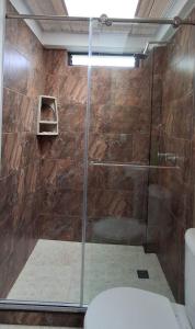a shower with a glass door in a bathroom at Cabaña privada cerca de Armenia Quiet Mountain View Country Home in Salento +19 photos