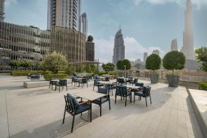 a patio with tables and chairs in a city at Vida Dubai Mall! 2 Bedroom with Burj Khalifa View! Direct Access to Dubai Mall in Dubai