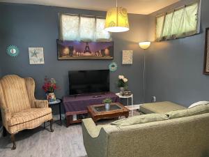 a living room with a couch and a television at Pasadena single house in Pasadena