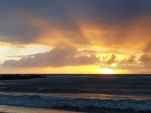 a sunset over the ocean with the sun setting at Luxury Retreat in Lonstrup Oasis-By Traum in Hjørring