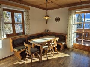 a dining room with a table and chairs at Achthütte in Grossarl