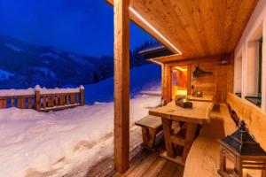 a log cabin in the snow at night with a desk at Druckfeichter Hütte in Auberg