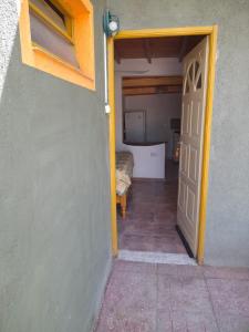 a door leading into a room with a bedroom at Camping Agua Clara-EL Mundo del Rock in Miramar
