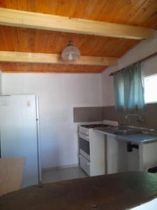 a kitchen with a sink and a stove at Camping Agua Clara-EL Mundo del Rock in Miramar +5 photos