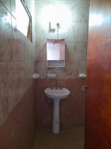 a bathroom with a sink and a mirror at Camping Agua Clara-EL Mundo del Rock in Miramar