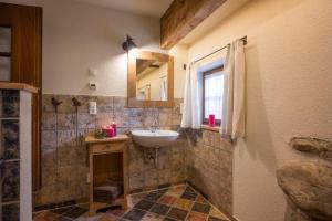 a bathroom with a sink and a mirror at Chalet Unterleming in Angerberg +1 photo