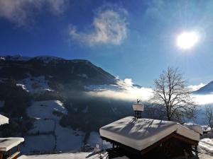 ein schneebedecktes Dach mit einer Lampe auf einem Berggipfel in der Unterkunft Naturchalet INSToul in Luttach