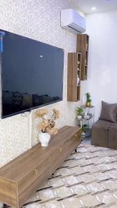 een woonkamer met een grote flatscreen-tv aan de muur bij Modern Stay in Nouakchott +10 foto's