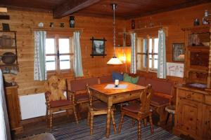 a dining room with a wooden table and chairs at Stallerhütte in Bachwinkl +15 photos