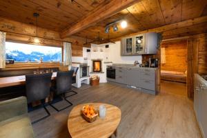 a kitchen and dining room with a table in a cabin at Hungarhub Hütte in Grossarl