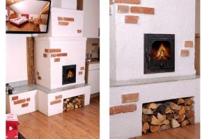 a fireplace made out of brick with a fire place at Almdorf Katschberg in Katschberghöhe +12 photos