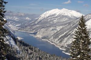 a view of a snowy mountain range with a lake at Alpen-Chalets Achensee in Häusern