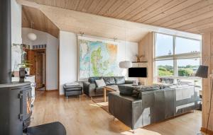 a living room with a couch and a tv at Nice Home In Tarm With Sauna in Højsand