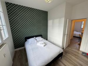 Ένα ή περισσότερα κρεβάτια σε δωμάτιο στο Appartement lumineux et moderne proche gare