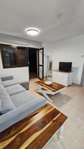 a living room with a couch and a table at Casa Galena in Corralejo