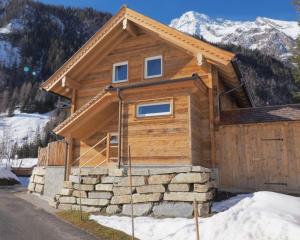 a log cabin in the mountains with snow at Chalet Alteck in Rauris