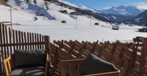 a bench sitting on top of a snow covered mountain at Chalet Alteck in Rauris