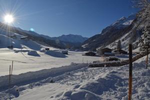 a snow covered mountain with the sun in the background at Chalet Alteck in Rauris