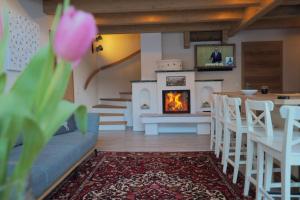 a living room with a couch and a fireplace at Chalet Alteck in Rauris +17 photos