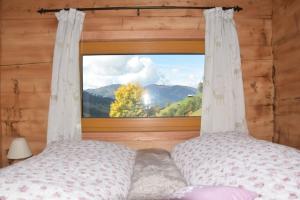 a bedroom with a bed and a window with a view at Achtchalet in Grossarl