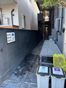 two parking meters sitting in front of a building at BUNKA HOUSE OSAKA room d in Osaka