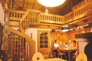 a group of people sitting at a table in a restaurant at Alpine-Lodges Petra in Hintersauerwald
