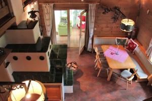 an overhead view of a kitchen with a table and a stove at Alpine-Lodges Petra in Hintersauerwald +12 photos