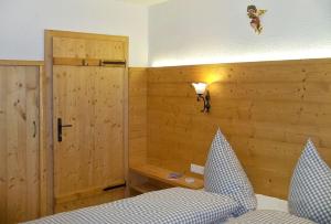 a bedroom with a bed and a wooden wall at Bergchalet Klausner Kuschelsuite in Ramsberg