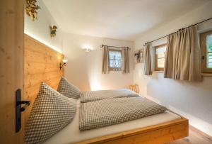 a bedroom with a bed and two pillows on it at Bergchalet Klausner Kuschelsuite in Ramsberg +6 photos