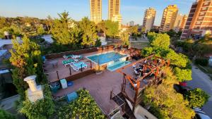 an overhead view of a swimming pool in a city at Hotel Don Carlos in Villa Gesell