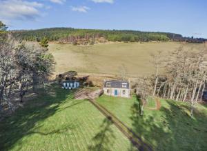 an aerial view of a house in a field at Cosy Cottage on the Whisky Trail in Haugh of Glass